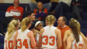 Coach Gibson instructs his team during the Spartans' win on Friday.