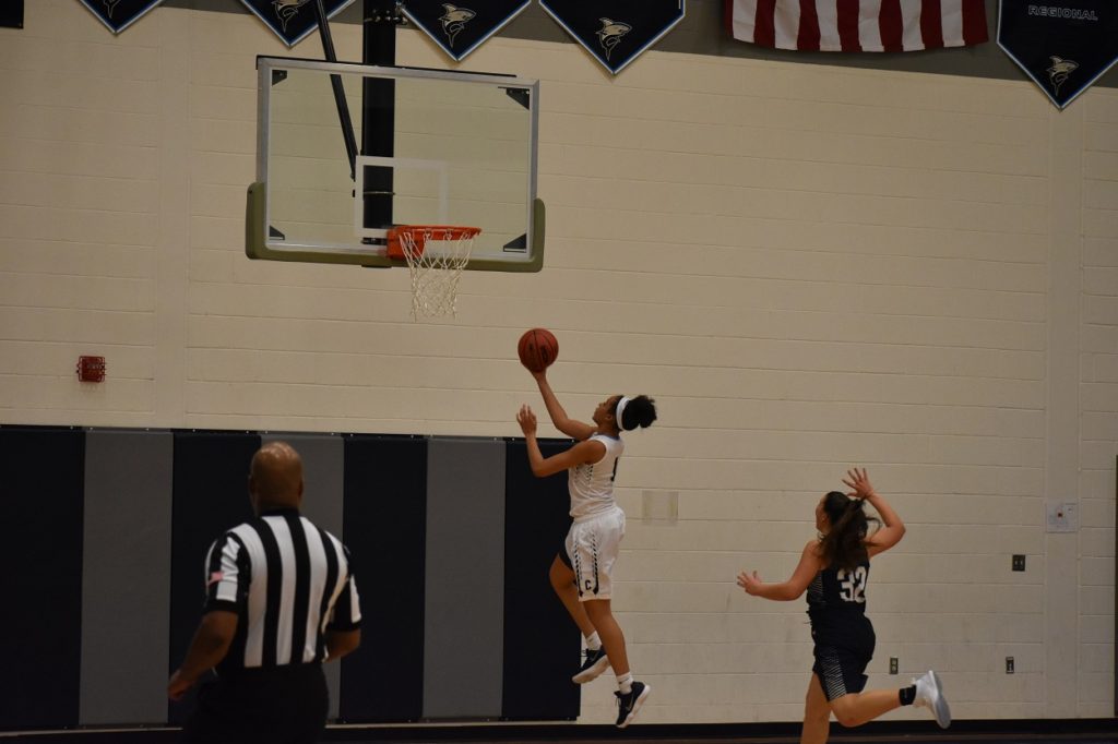 Freshman Alyssa Andrews converts a lay-up on a fast break. Andrews led the team with 18 points.