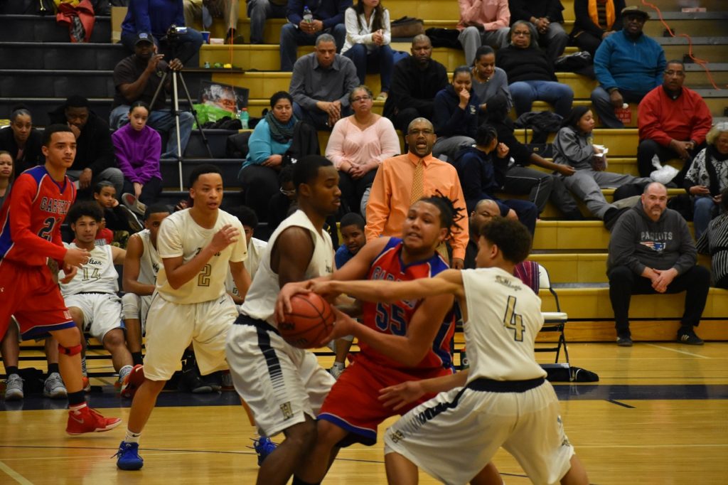 Hylton's Nicholas Peterson and Traquan Cheek put the clamps on Gar-Field's Cory Wilson.