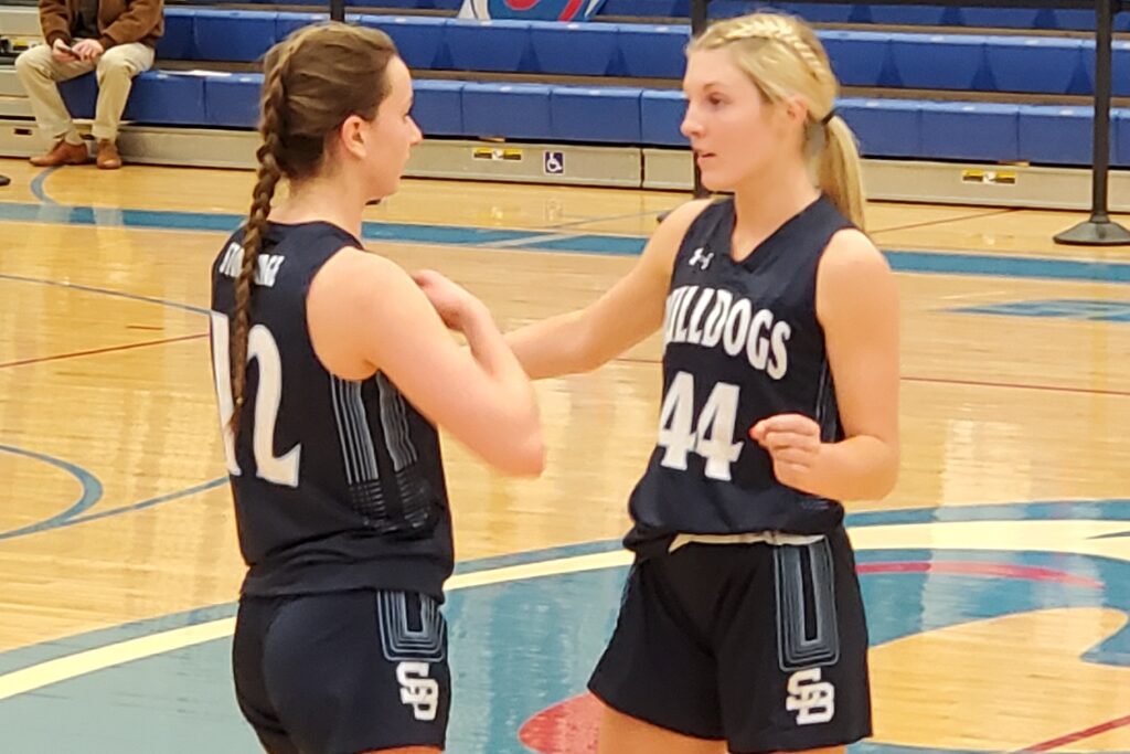 Madison Moon (right) confers with Gianna Cunningham. Moon had two key steals and buckets in the fourth quarter.