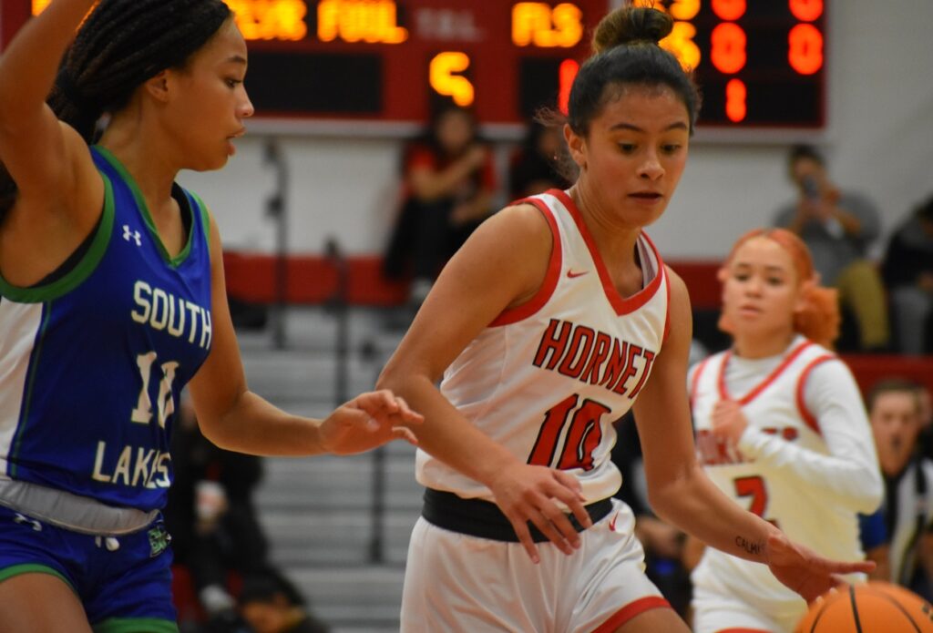 Annelise Castillo drives by the Seahawks' Mia Branch Friday night.